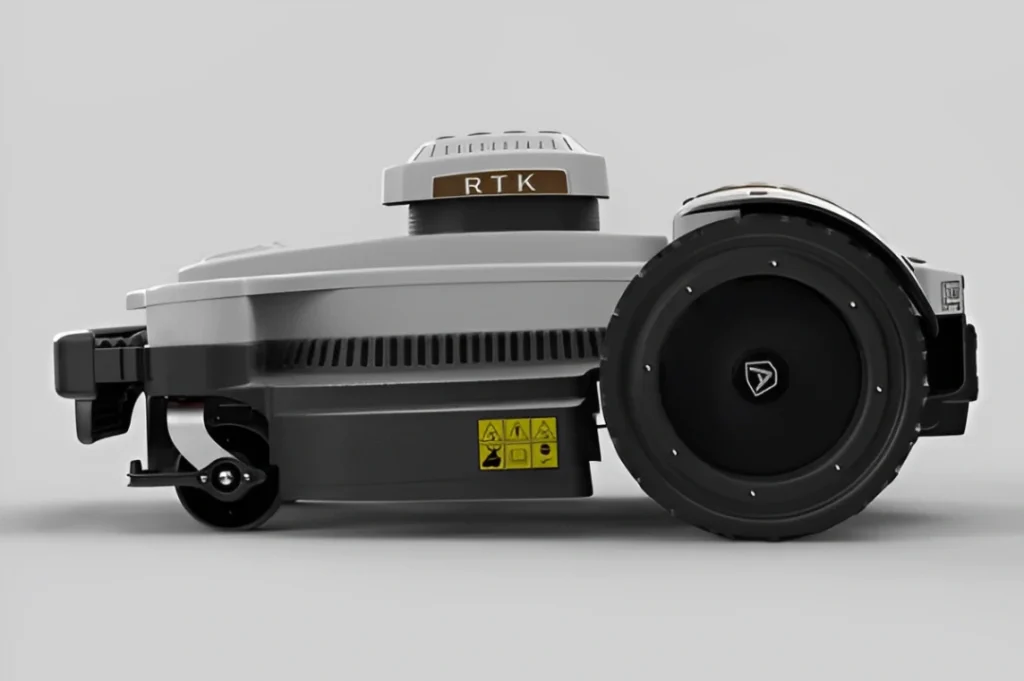Side view of a gray RTK-enabled robotic mower with large wheels and safety labels.